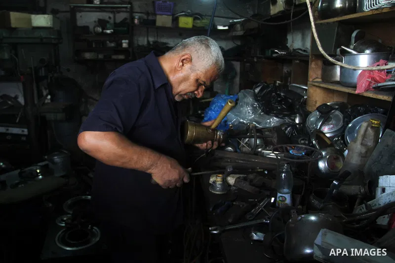 A Palestinian man works at his work-shop in the saturday's popular market in Rafah in the southern Gaa strip, on September 5, 2015. Photo by Abed Rahim Khatib