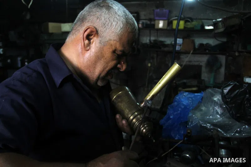 A Palestinian man works at his work-shop in the saturday's popular market in Rafah in the southern Gaa strip, on September 5, 2015. Photo by Abed Rahim Khatib