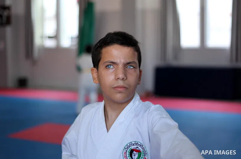 A visually impaired Palestinian boy take parts in a Karate class at al-Masthal club in Gaza city Sep. 06, 2015. The training is held twice a week by the club to lift the morale of the children, trainers said. Photo by As...