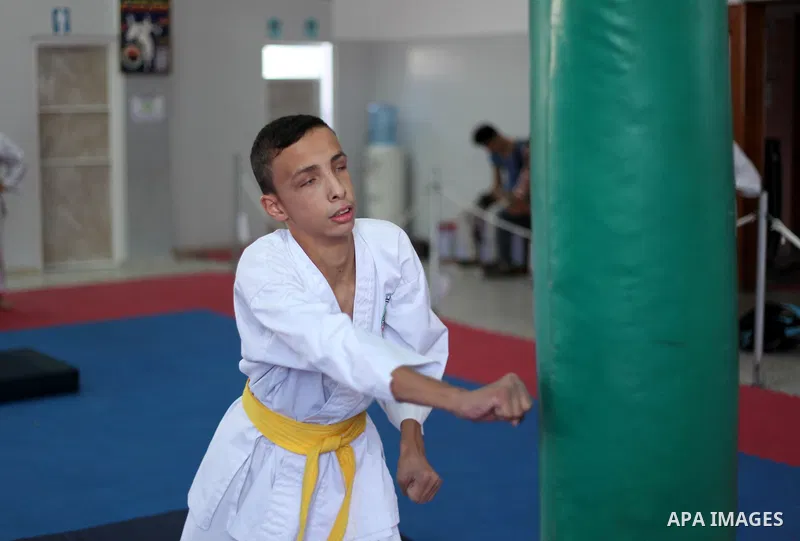 A visually impaired Palestinian boy take parts in a Karate class at al-Masthal club in Gaza city Sep. 06, 2015. The training is held twice a week by the club to lift the morale of the children, trainers said. Photo by As...