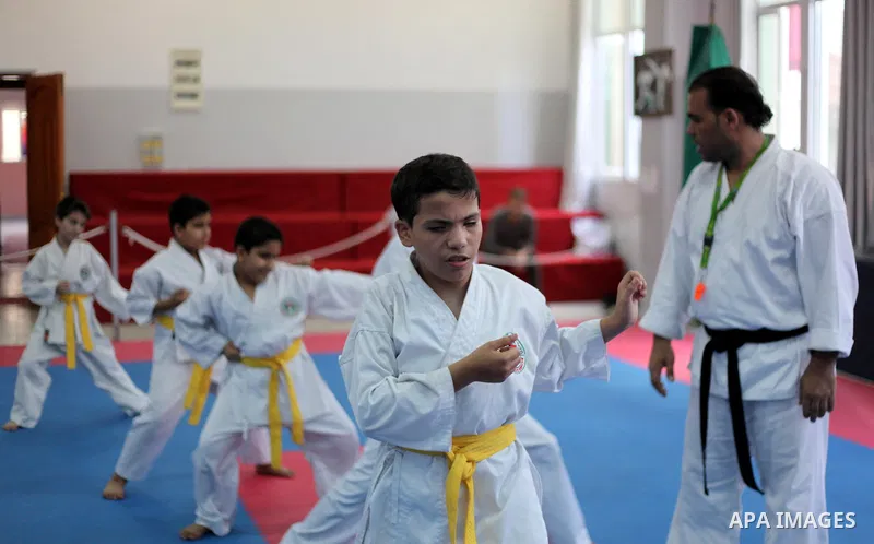 A trainer gives instructions to Blind and visually impaired Palestinian boys as they take part in a Karate class at al-Masthal club in Gaza city Sep. 06, 2015. The training is held twice a week by the club to lift the mo...