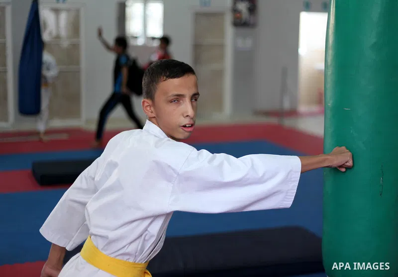 A visually impaired Palestinian boy take parts in a Karate class at al-Masthal club in Gaza city Sep. 06, 2015. The training is held twice a week by the club to lift the morale of the children, trainers said. Photo by As...