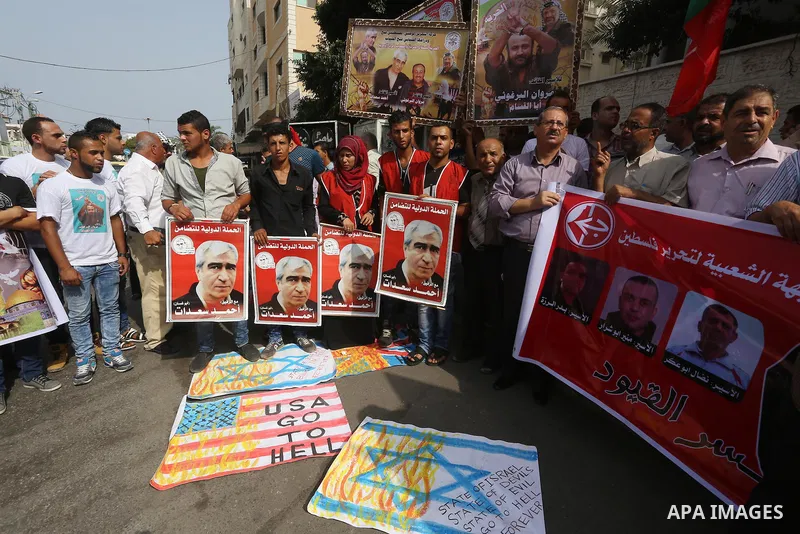 Palestinians take part in a protest demanding release the prisoners in Israeli jails, in front of Red cross office, in Gaza city, on Sep. 07, 2015. Photo by Mohammed Asad
