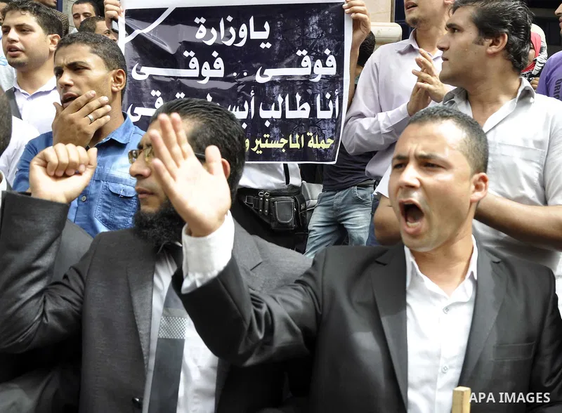 Egyptian teachers and students shout slogans during a protest against the Minister of Education Moheb El-Rafie, and demanding for his dismissal, outside the journalists syndicate, in Cairo on September 10, 2015. Photo by...