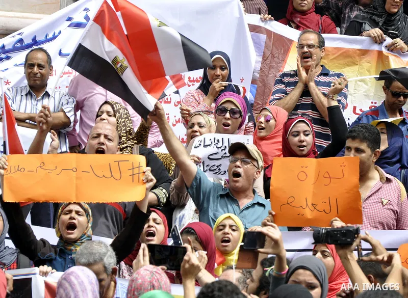 Egyptian teachers and students shout slogans during a protest against the Minister of Education Moheb El-Rafie, and demanding for his dismissal, outside the journalists syndicate, in Cairo on September 10, 2015. Photo by...