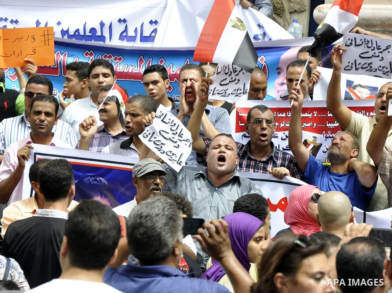 Egyptian teachers and students shout slogans during a protest against the Minister of Education Moheb El-Rafie, and demanding for his dismissal, outside the journalists syndicate, in Cairo on September 10, 2015. Photo by...