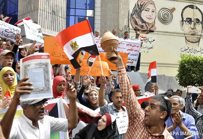 Egyptian teachers and students shout slogans during a protest against the Minister of Education Moheb El-Rafie, and demanding for his dismissal, outside the journalists syndicate, in Cairo on September 10, 2015. Photo by...