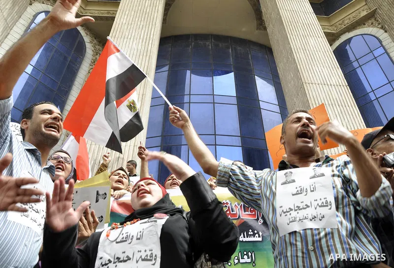Egyptian teachers and students shout slogans during a protest against the Minister of Education Moheb El-Rafie, and demanding for his dismissal, outside the journalists syndicate, in Cairo on September 10, 2015. Photo by...