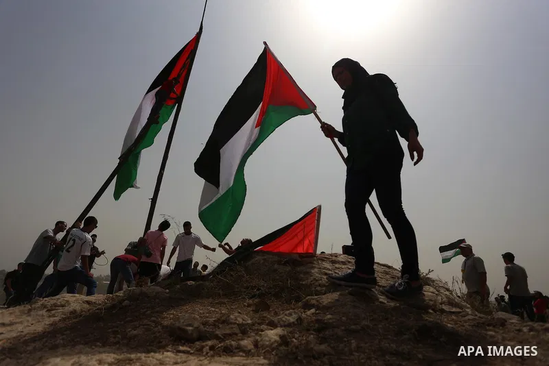 Palestinian protesters wave national flags during a demonstration against Jewish settlements in the West Bank village of Nabi Saleh, near Ramallah September 11, 2015. The UN General Assembly has overwhelmingly voted in f...