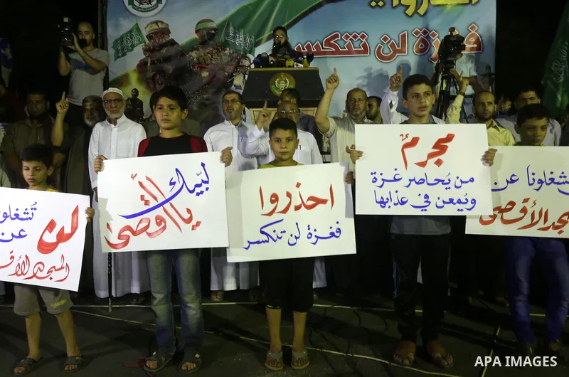Palestinian supporters of Hamas movement take part in a protest against an Israeli police raid on Jerusalem's al-Aqsa mosque, and against the Palestinian President Mahmoud Abbas, in Gaza city on September 15, 2015. Photo...