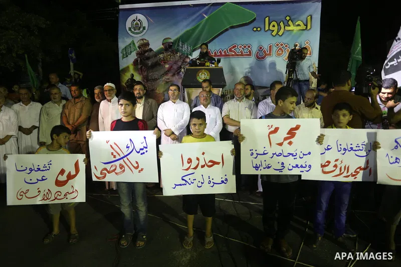 Palestinian supporters of Hamas movement take part in a protest against an Israeli police raid on Jerusalem's al-Aqsa mosque, and against the Palestinian President Mahmoud Abbas, in Gaza city on September 15, 2015. Photo...