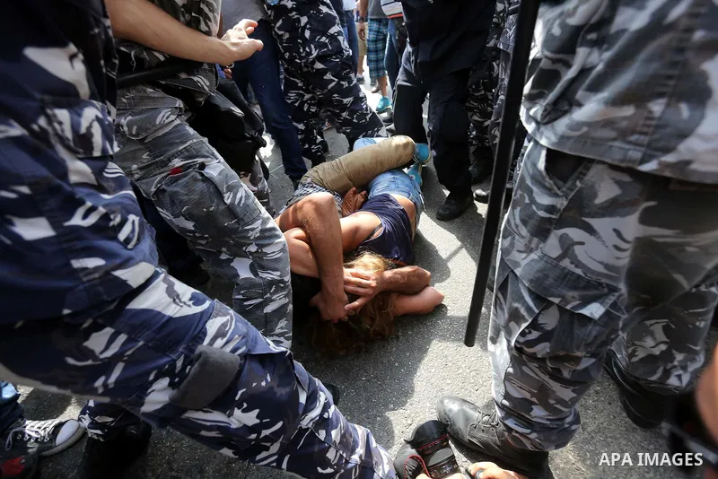 Lebanese activists from 'You Stink' campaign clash with riot police after a protest against today s session of a dialogue of top political figures, accused by the group of failing to resolve a crisis over rubbish buildin...