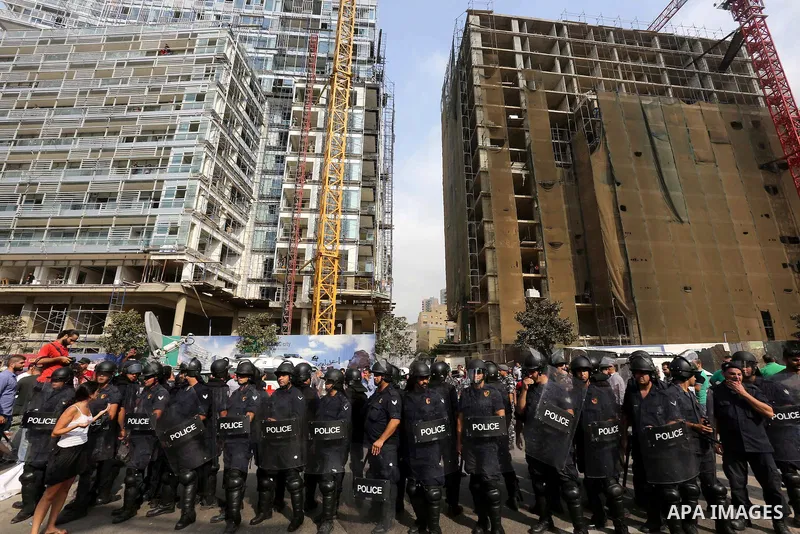 A Lebanese activist from 'You Stink' campaign shouts slogans in front of riot police during a protest against today s session of a dialogue of top political figures, accused by the group of failing to resolve a crisis ov...