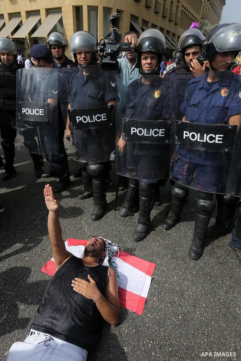 Lebanese activists from 'You Stink' campaign clash with riot police after a protest against today s session of a dialogue of top political figures, accused by the group of failing to resolve a crisis over rubbish buildin...