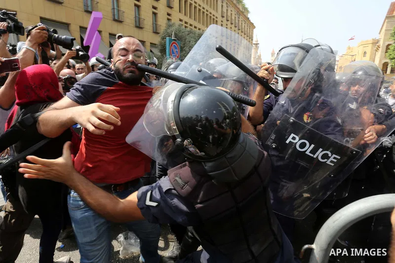 Lebanese activists from 'You Stink' campaign clash with riot police after a protest against today s session of a dialogue of top political figures, accused by the group of failing to resolve a crisis over rubbish buildin...