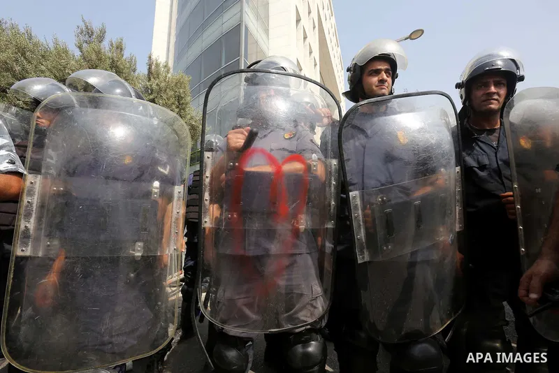 Riot police stand guard as Lebanese activists from 'You Stink' campaign protest against today s session of a dialogue of top political figures, accused by the group of failing to resolve a crisis over rubbish building up...