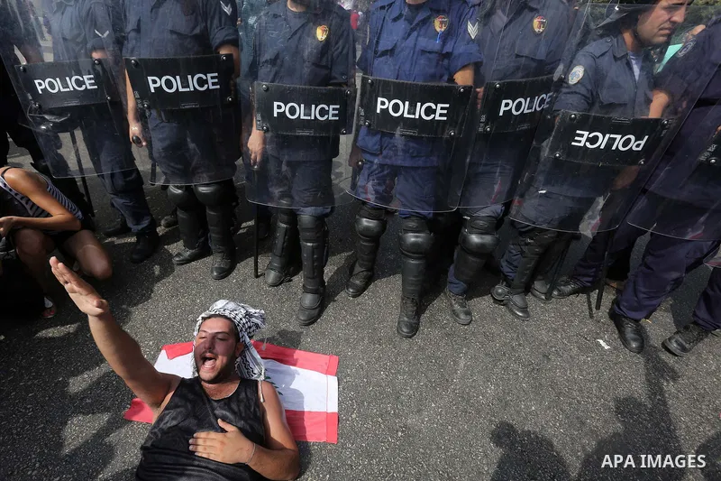 Lebanese activists from 'You Stink' campaign clash with riot police after a protest against today s session of a dialogue of top political figures, accused by the group of failing to resolve a crisis over rubbish buildin...