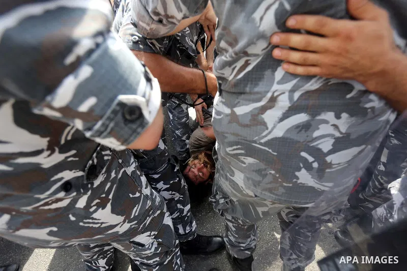 Lebanese activists from 'You Stink' campaign clash with riot police after a protest against today s session of a dialogue of top political figures, accused by the group of failing to resolve a crisis over rubbish buildin...