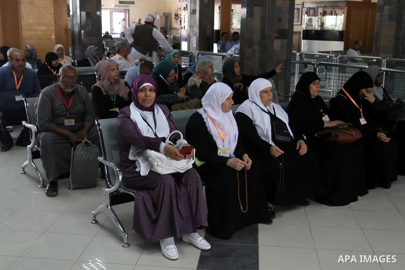 Families of Palestinian martyrs wait at the Rafah border crossing between Egypt and the southern Gaza Strip, on September 17, 2015, as they head to the annual hajj pilgrimage in Saudi Arabia's holy city of Mecca. Custodi...
