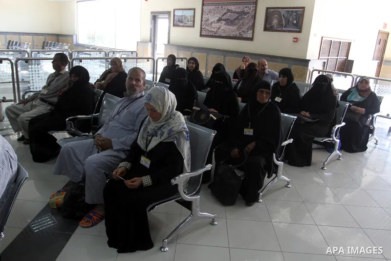 Families of Palestinian martyrs wait at the Rafah border crossing between Egypt and the southern Gaza Strip, on September 17, 2015, as they head to the annual hajj pilgrimage in Saudi Arabia's holy city of Mecca. Custodi...
