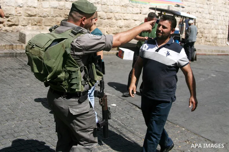 An Israeli policeman prevents a Palestinian muslim man from entering the Al-Aqsa mosque to perform he traditional Friday prayers, as Israeli police blocks the access to Al-Aqsa Mosque, outside the Old City walls in East...