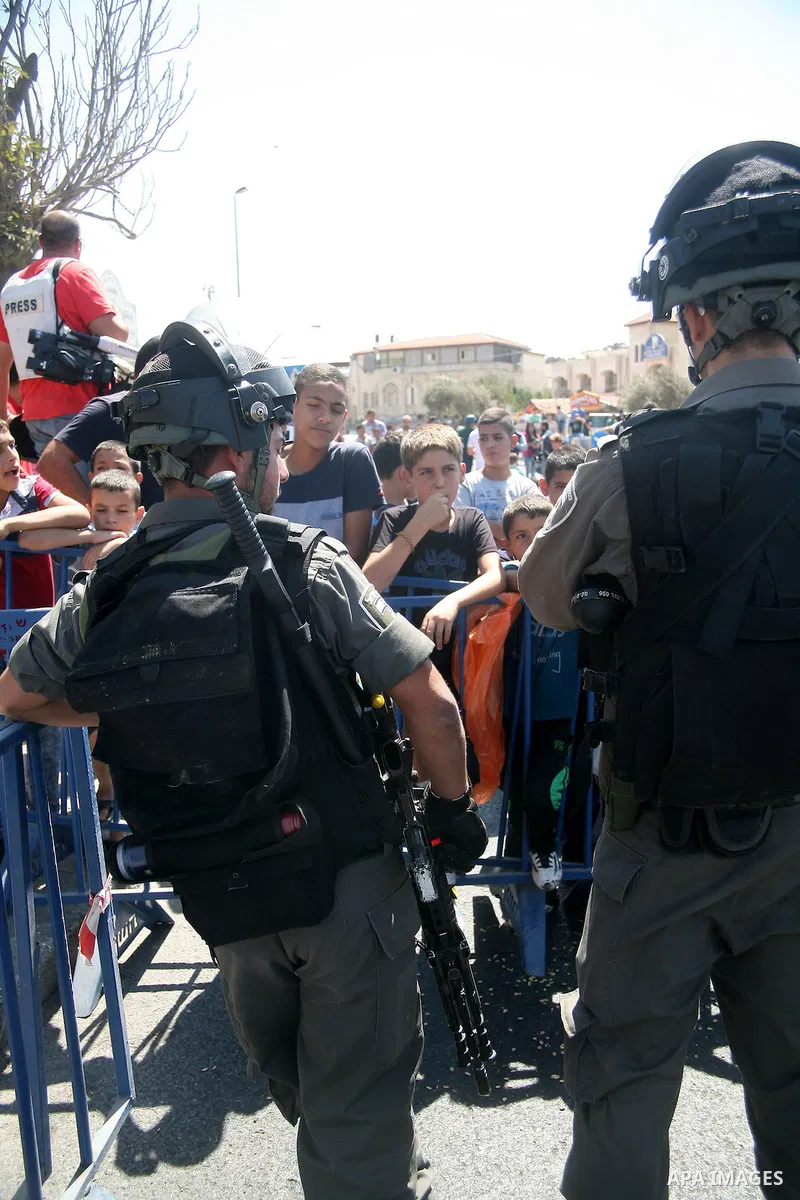 Palestinian Muslim worshippers, under the age of 40 years old, perform the traditional Friday prayers on a street as Israeli police blocks the access to Al-Aqsa Mosque, outside the Old City walls in East Jerusalem on Sep...