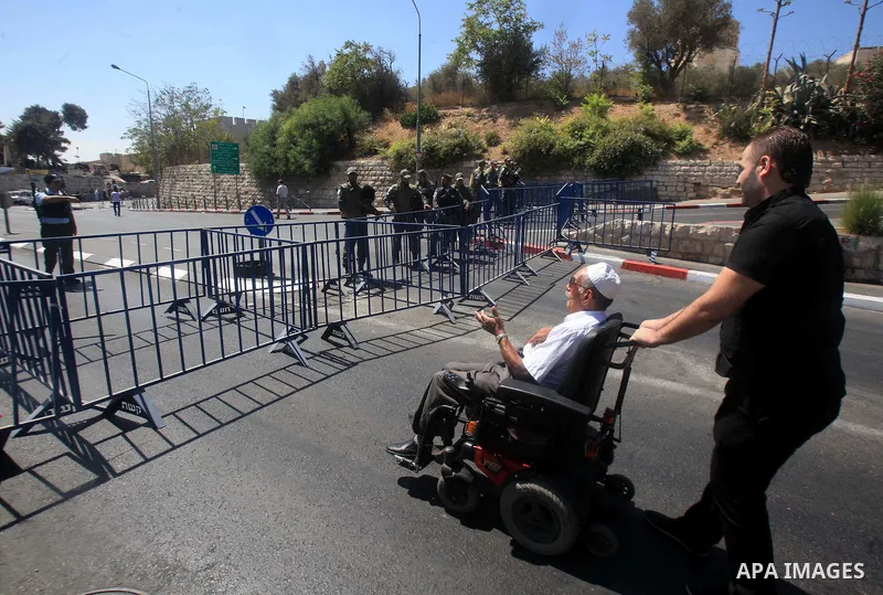 A Palestinian muslim man tries to enter the Al-Aqsa mosque to perform he traditional Friday prayers, as Israeli police blocks the access to Al-Aqsa Mosque, outside the Old City walls in East Jerusalem on September 18, 20...