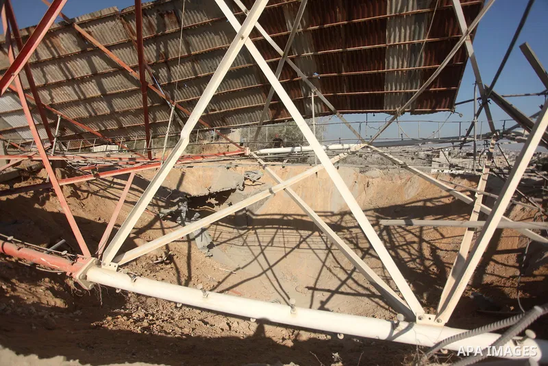Palestinians look at the damage following an Israeli air strike overnight in the northern Gaza strip of Beit Hanun on September 19, 2015. Two rockets were fired into southern Israel by Palestinian militants in Gaza, caus...