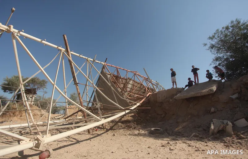 Palestinians look at the damage following an Israeli air strike overnight in the northern Gaza strip of Beit Hanun on September 19, 2015. Two rockets were fired into southern Israel by Palestinian militants in Gaza, caus...
