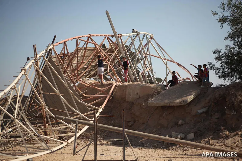 Palestinians look at the damage following an Israeli air strike overnight in the northern Gaza strip of Beit Hanun on September 19, 2015. Two rockets were fired into southern Israel by Palestinian militants in Gaza, caus...