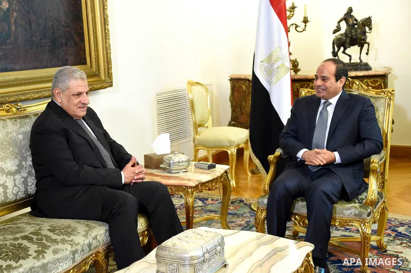 A handout picture made available by the Egyptian Presidency shows Egyptian President Abdel Fattah al-Sisi (R) meeting with Ibrahim Mahlab after he was sworn in as Egypt's new assistant to the president of the republic an...
