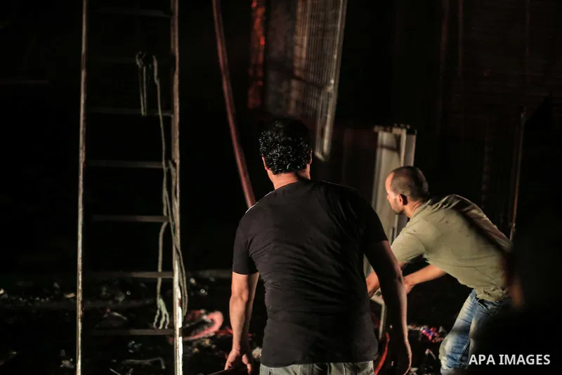 Egyptian firefighters inspect the damage following a fire broke out in al-Gamaliya district, in Cairo on September 20, 2015. At least 4 persons were injured as a number of stores and shops caught fire today, morning, in...