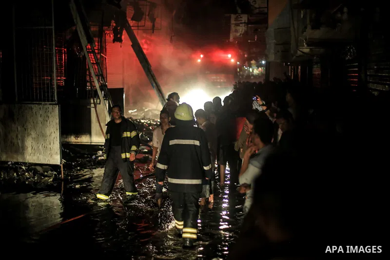 Egyptian firefighters inspect the damage following a fire broke out in al-Gamaliya district, in Cairo on September 20, 2015. At least 4 persons were injured as a number of stores and shops caught fire today, morning, in...