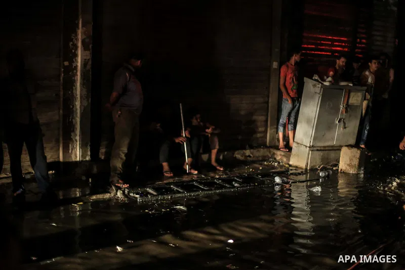 Egyptian firefighters inspect the damage following a fire broke out in al-Gamaliya district, in Cairo on September 20, 2015. At least 4 persons were injured as a number of stores and shops caught fire today, morning, in...