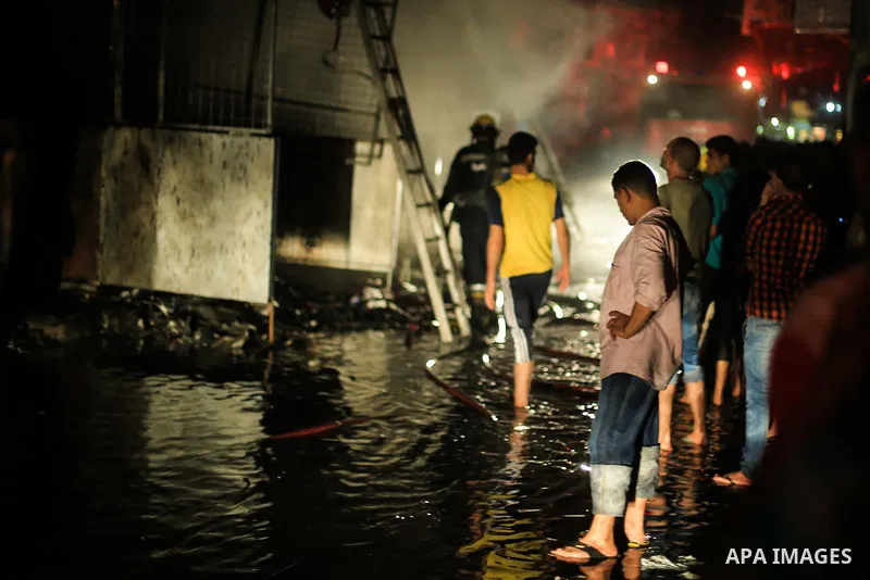 Egyptian firefighters inspect the damage following a fire broke out in al-Gamaliya district, in Cairo on September 20, 2015. At least 4 persons were injured as a number of stores and shops caught fire today, morning, in...