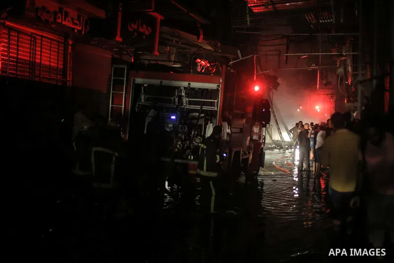 Egyptian firefighters inspect the damage following a fire broke out in al-Gamaliya district, in Cairo on September 20, 2015. At least 4 persons were injured as a number of stores and shops caught fire today, morning, in...