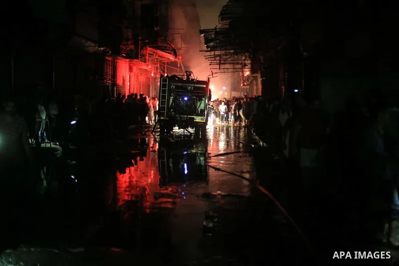 Egyptian firefighters inspect the damage following a fire broke out in al-Gamaliya district, in Cairo on September 20, 2015. At least 4 persons were injured as a number of stores and shops caught fire today, morning, in...