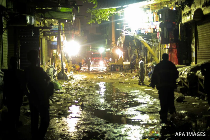 Egyptian firefighters inspect the damage following a fire broke out in al-Gamaliya district, in Cairo on September 20, 2015. At least 4 persons were injured as a number of stores and shops caught fire today, morning, in...