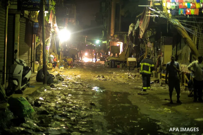 Egyptian firefighters inspect the damage following a fire broke out in al-Gamaliya district, in Cairo on September 20, 2015. At least 4 persons were injured as a number of stores and shops caught fire today, morning, in...