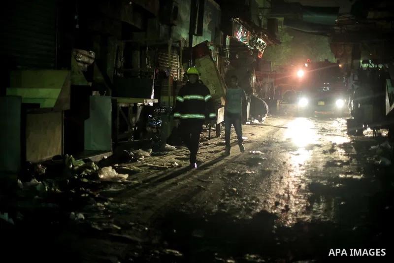 Egyptian firefighters inspect the damage following a fire broke out in al-Gamaliya district, in Cairo on September 20, 2015. At least 4 persons were injured as a number of stores and shops caught fire today, morning, in...