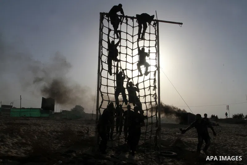 Palestinian militants of Al-Aqsa Martyrs' Brigades, a group linked to the Fatah movement, demonstrate their skills during a training in Khan Yunis, southern Gaza Strip, on September 20, 2015. Photo by Abed Rahim Khatib