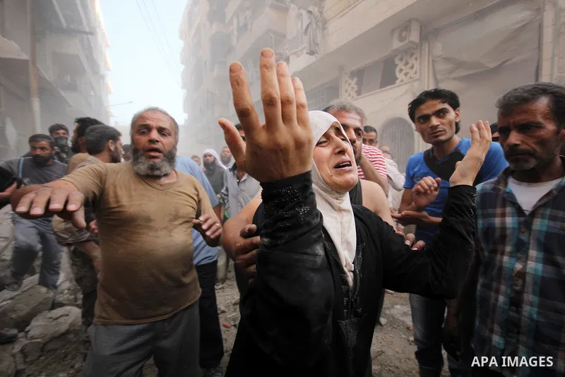 A Syrian woman mourns following an air strike by government forces on the al-Mowasalat neighbourhood of the northern Syrian city of Aleppo on September 20, 2015. Photo by Ameer al-Halbi