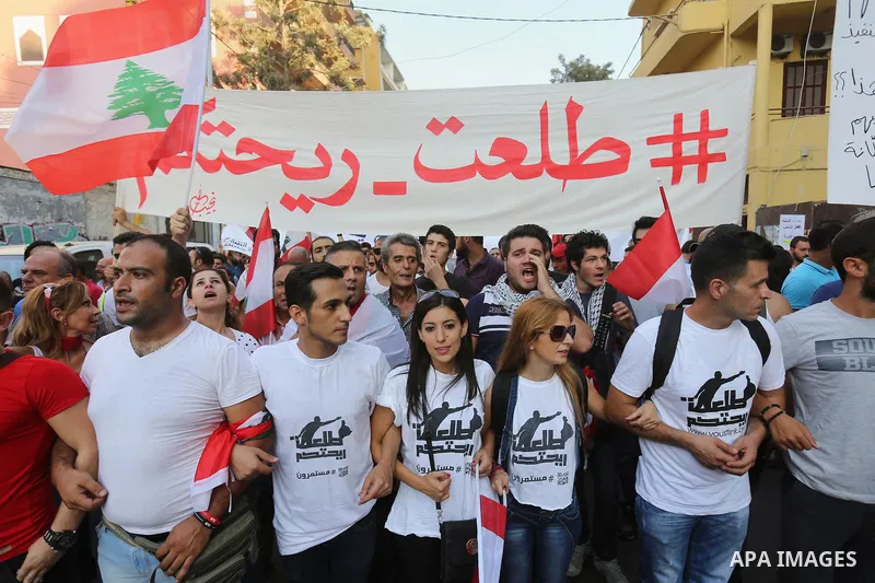 Protesters chant slogans and raise Lebanese national flags during a protest against perceived government failures, including a rubbish disposal crisis, in downtown Beirut, Lebanon September 20, 2015. Photo by Marwan Taht...