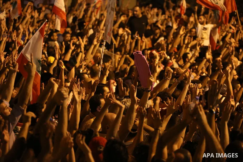 Protesters chant slogans and raise Lebanese national flags during a protest against perceived government failures, including a rubbish disposal crisis, in downtown Beirut, Lebanon September 20, 2015. Photo by Marwan Taht...