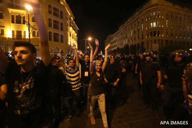 Protesters chant slogans and raise Lebanese national flags during a protest against perceived government failures, including a rubbish disposal crisis, in downtown Beirut, Lebanon September 20, 2015. Photo by Marwan Taht...