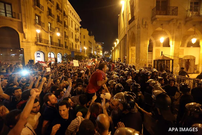 Protesters chant slogans and raise Lebanese national flags during a protest against perceived government failures, including a rubbish disposal crisis, in downtown Beirut, Lebanon September 20, 2015. Photo by Marwan Taht...