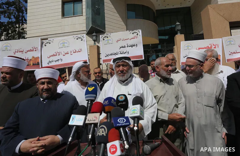 Members of the Palestine Scholars Association take part in a protest against the Israeli police raid on Jerusalem's al-Aqsa mosque on Tuesday, in Gaza city, September 21, 2015. Israel deployed hundreds of extra police ar...