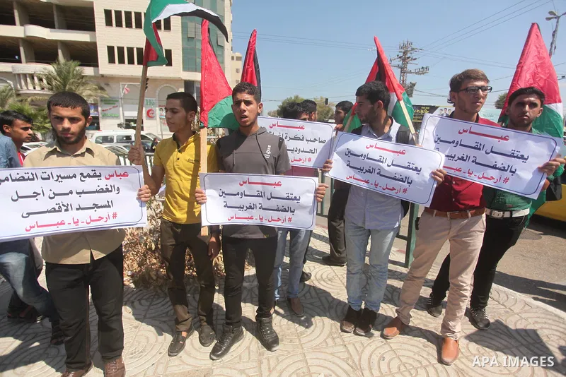 Palestinian youths take part in a protest against an Israeli police raid on Jerusalem's al-Aqsa mosque, and against the Palestinian President Mahmoud Abbas in Gaza city, on Sept. 21, 2015. Israel deployed hundreds of ext...