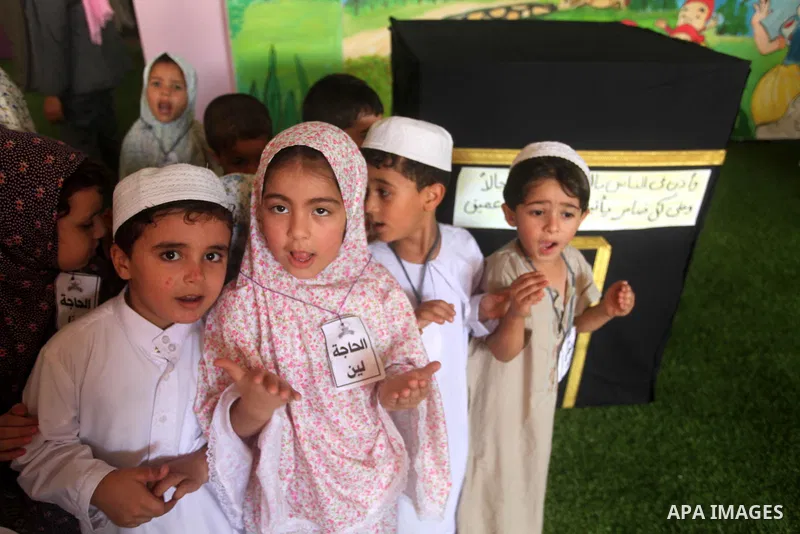 Palestinian children gather around a makeshift cube representing the holy Kaaba in Gaza city, on Sept. 21, 2015, as part of training children how to perform Hajj pilgrimage. Muslims from around the world flood Saudi city...