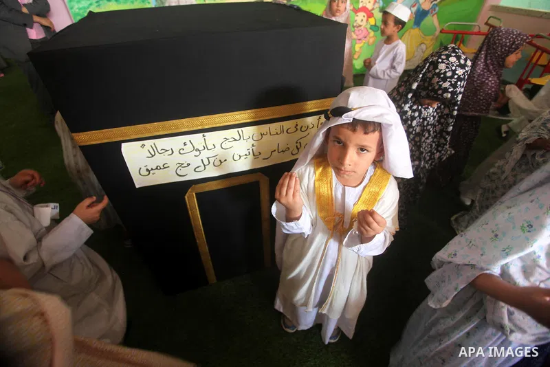 Palestinian children gather around a makeshift cube representing the holy Kaaba in Gaza city, on Sept. 21, 2015, as part of training children how to perform Hajj pilgrimage. Muslims from around the world flood Saudi city...